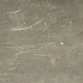 Metallic fabric texture, muted gray “laminato platino” with white speckles, displaying a rippled, diagonally-lined surface and subtle reflectivity.